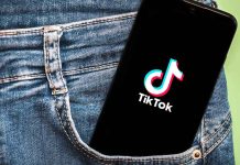 Phone with TikTok logo in jeans pocket.