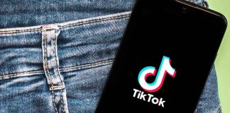 Phone with TikTok logo in jeans pocket.