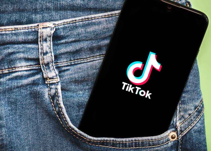 Phone with TikTok logo in jeans pocket.