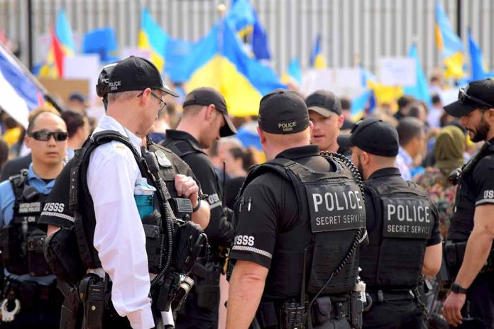 Police officers gathered near a crowd with flags.