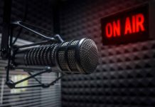 Microphone in studio with "On Air" sign.