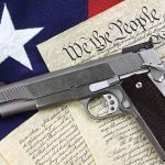 Gun on U.S. Constitution and flag.