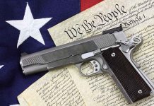 Gun on U.S. Constitution and flag.