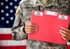 Soldier holding red top secret file folder.