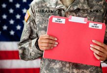 Soldier holding red top secret file folder.