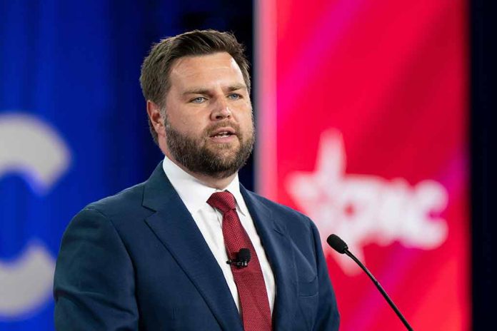 Man speaking at a conference, wearing a suit.