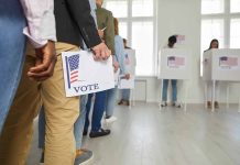 People standing in line holding voting papers