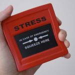 Hand holding red stress relief device