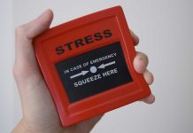 Hand holding red stress relief device