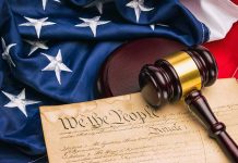 Gavel on U.S. Constitution with American flag