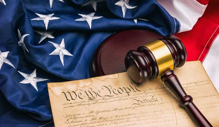 Gavel on U.S. Constitution with American flag