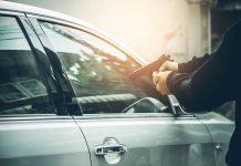 Person pointing gun at a car window