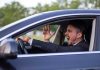 Man yelling inside a car, looking frustrated