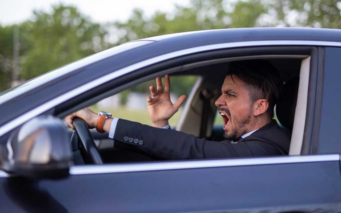 Man yelling inside a car, looking frustrated