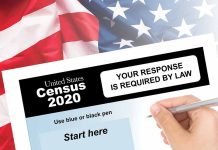 Hand filling out the U.S. Census 2020 form.