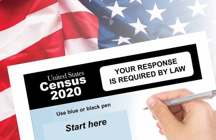 Hand filling out the U.S. Census 2020 form.