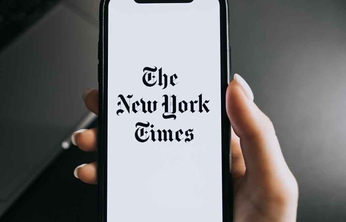 Hand holding phone with New York Times logo.