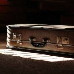 Brown suitcase in dimly lit room