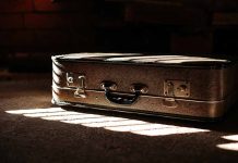 Brown suitcase in dimly lit room