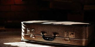 Brown suitcase in dimly lit room