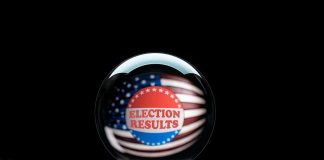 election results button hovering over outstretched hand.