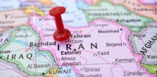 Red pushpin marking Iran on a map.