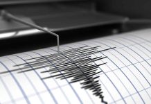 Seismograph needle recording earthquake activity on paper.