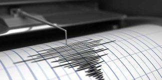 Seismograph needle recording earthquake activity on paper.