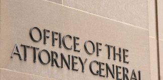 Office of the Attorney General sign on concrete wall.