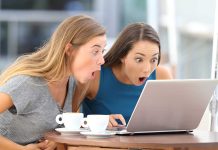 Two women surprised while looking at a laptop