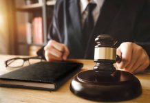 Judge holding gavel at desk