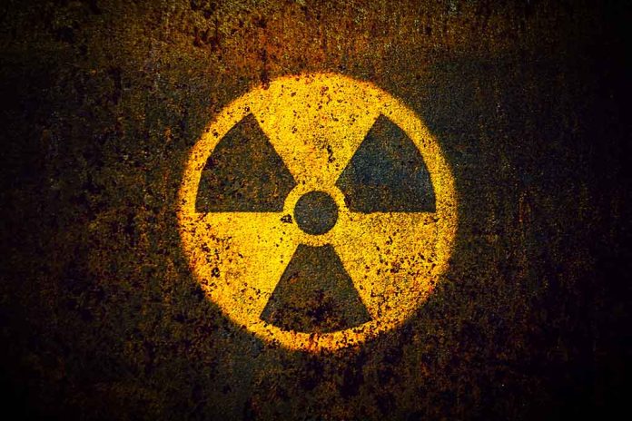 Yellow radiation warning symbol on rusty metal surface.