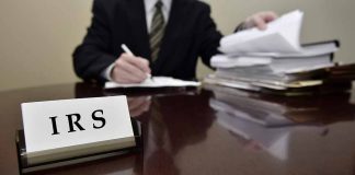 IRS sign on desk with person working