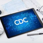 Tablet with CDC logo surrounded by medical equipment