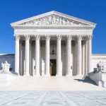 United States Supreme Court building under clear blue sky