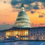 Capitol building at sunset with cloudy sky