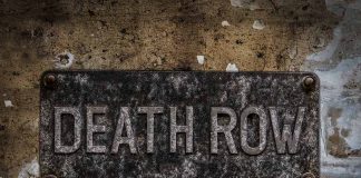 Weathered Death Row sign on aged concrete wall