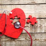 Red heart puzzle with stethoscope