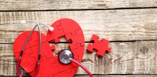 Red heart puzzle with stethoscope