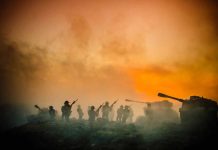 Soldiers and tanks in the foggy battlefield.