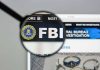 Magnifying glass over FBI logo on webpage