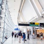 People walking in a brightly lit airport terminal