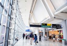 People walking in a brightly lit airport terminal