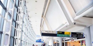 People walking in a brightly lit airport terminal