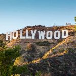 Hollywood sign on a hill with trees.