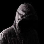 Person in a hooded jacket, face obscured.