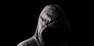 Person in a hooded jacket, face obscured.