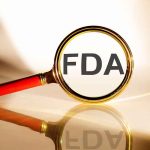 FDA under magnifying glass gold background