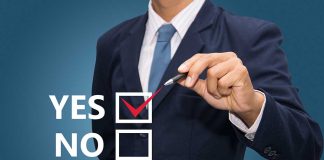 Man in suit selecting yes with pen