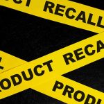 Yellow tape with "product recall" text on black background.